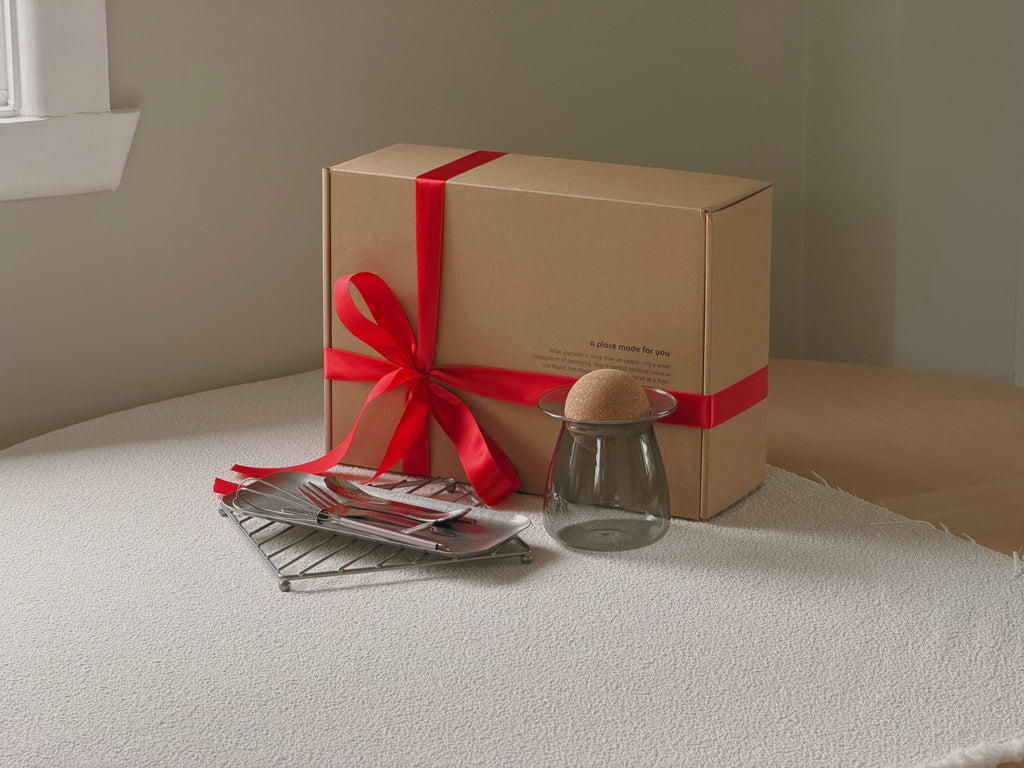 Gift box with a red ribbon on a white surface